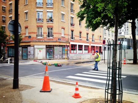 Parisian walks his plastic trucks on a quit Sunday afternoon